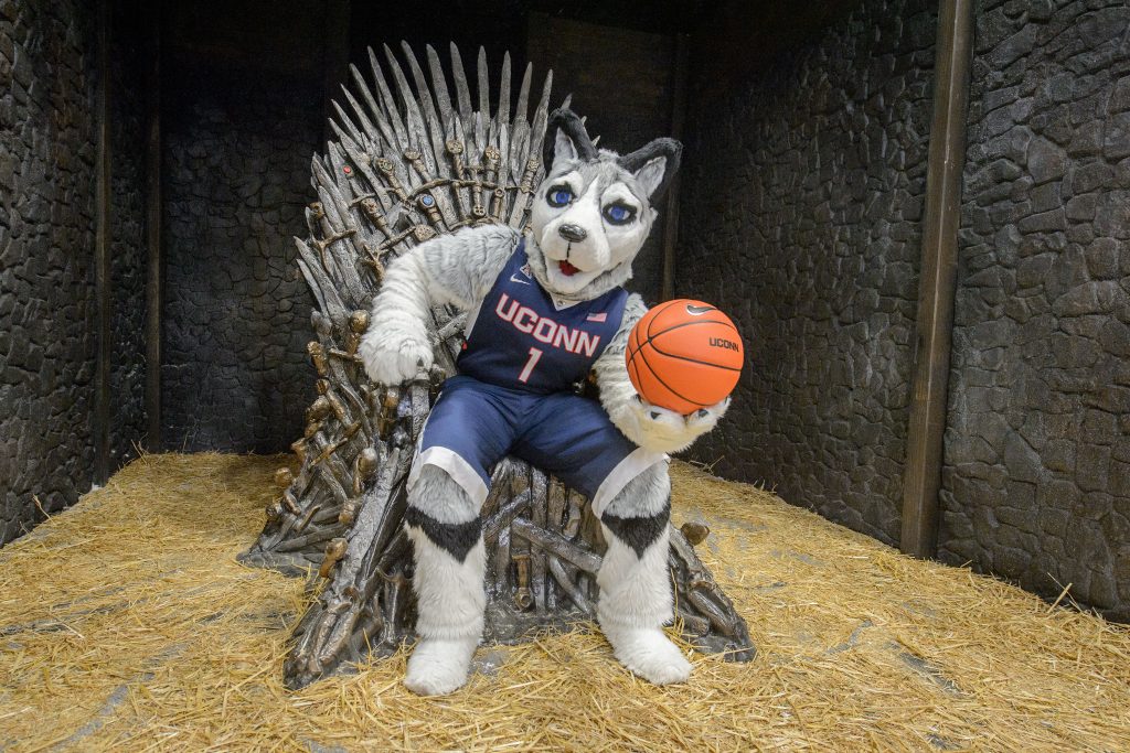 Jonathan the Husky sits on a replica of the Iron Throne from the TV show Game of Thrones at the Ratcliffe Hicks Arena. (Peter Morenus/UConn Photo)