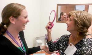 Amber Tillinghast with patient trying on wig