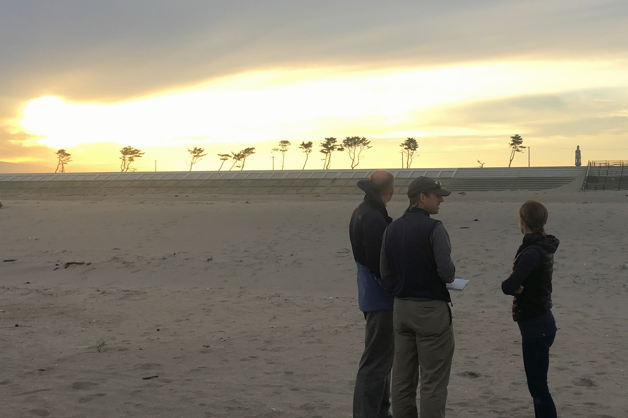 UConn professors on the beach near Sendai. Note the recently raised sea wall and trees with healthy branches indicating the height of the 2011 tsunami wave. (Photo courtesy of William Ouimet)