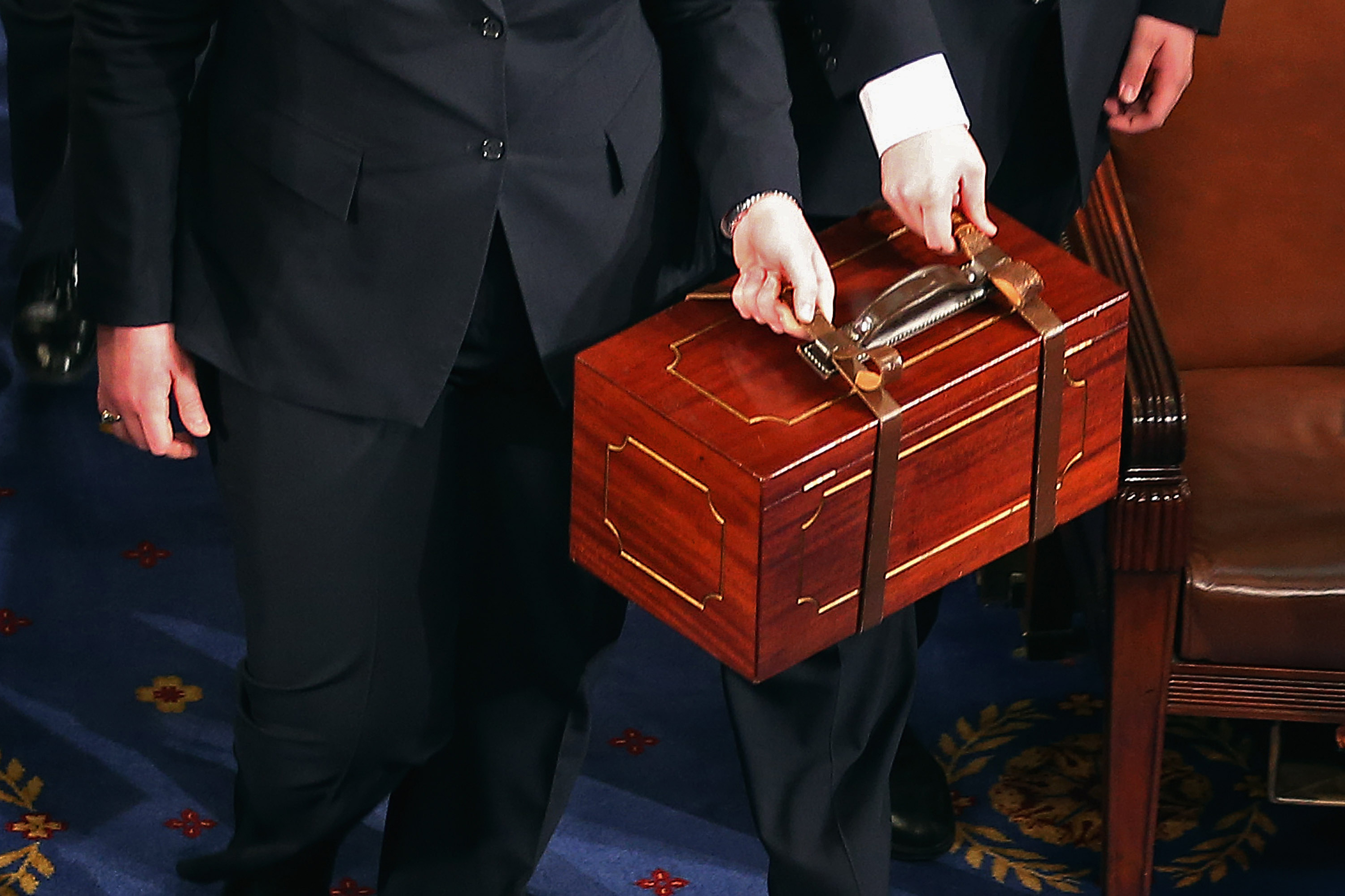 Senate pages carry bound wooden boxes containing the Electoral College votes from the 50 states into the House of Representatives chamber at the U.S. Capitol on Jan. 4, 2013 in Washington, D.C. (Photo by Chip Somodevilla/Getty Images)