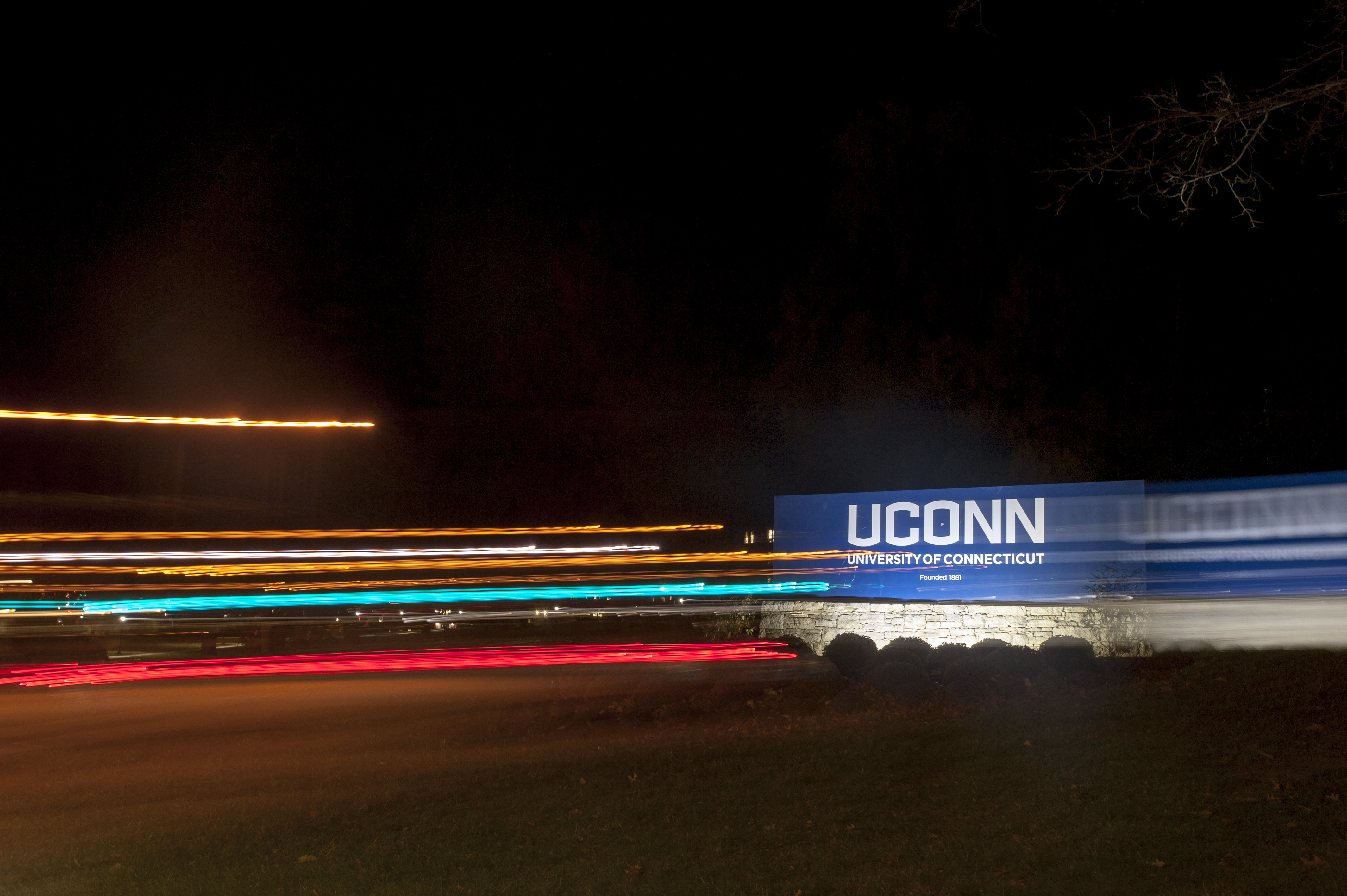 The UConn sign with motion. Familiar campus landmarks take on a different look in the dark. (Sean Flynn/UConn Photo)