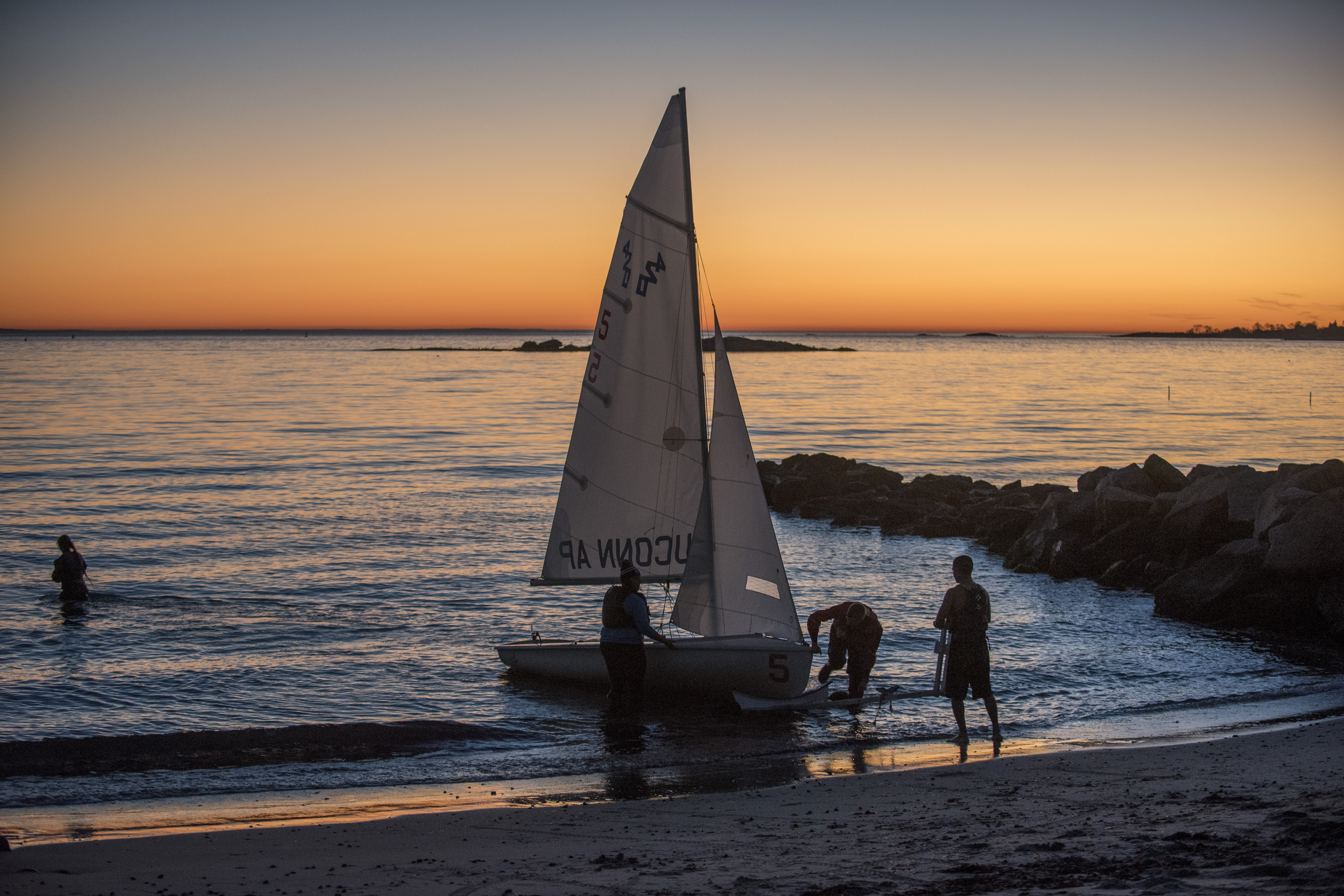The UConn sailing club sailing in Long Island Sound as the sun sets at the Avery Point campus on Nov. 18, 2016. (Sean Flynn/UConn Photo)