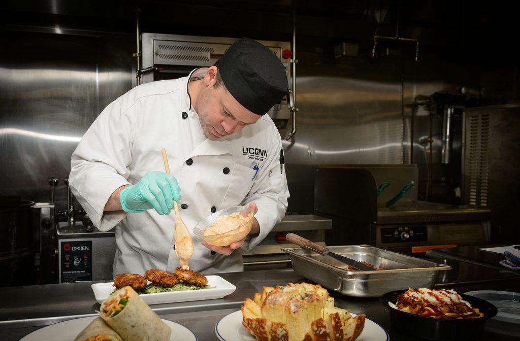 Rob Landolphi prepares vegan crab cakes at the Dining Services test kitchen in the Student Union.