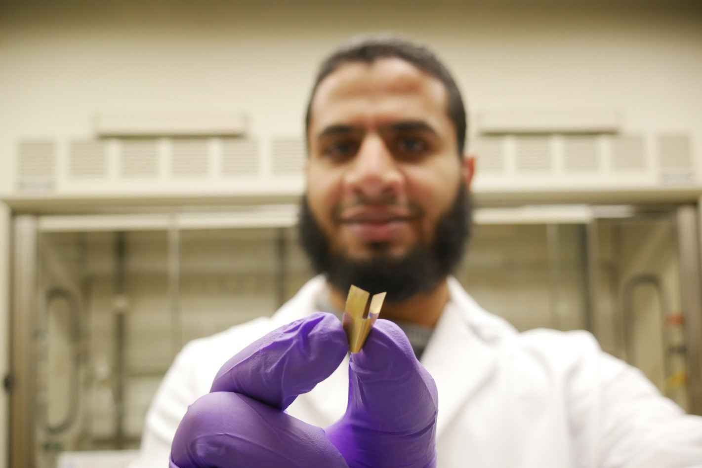 Chemistry Ph.D. student Islam Mosa holds an ultrathin implantable bioelectronic device he developed that is powered by a novel supercapacitor capable of generating enough power to sustain a cardiac pacemaker. It is more biocompatible and lasts much longer than existing pacemaker batteries. (Photo courtesy Islam Mosa)