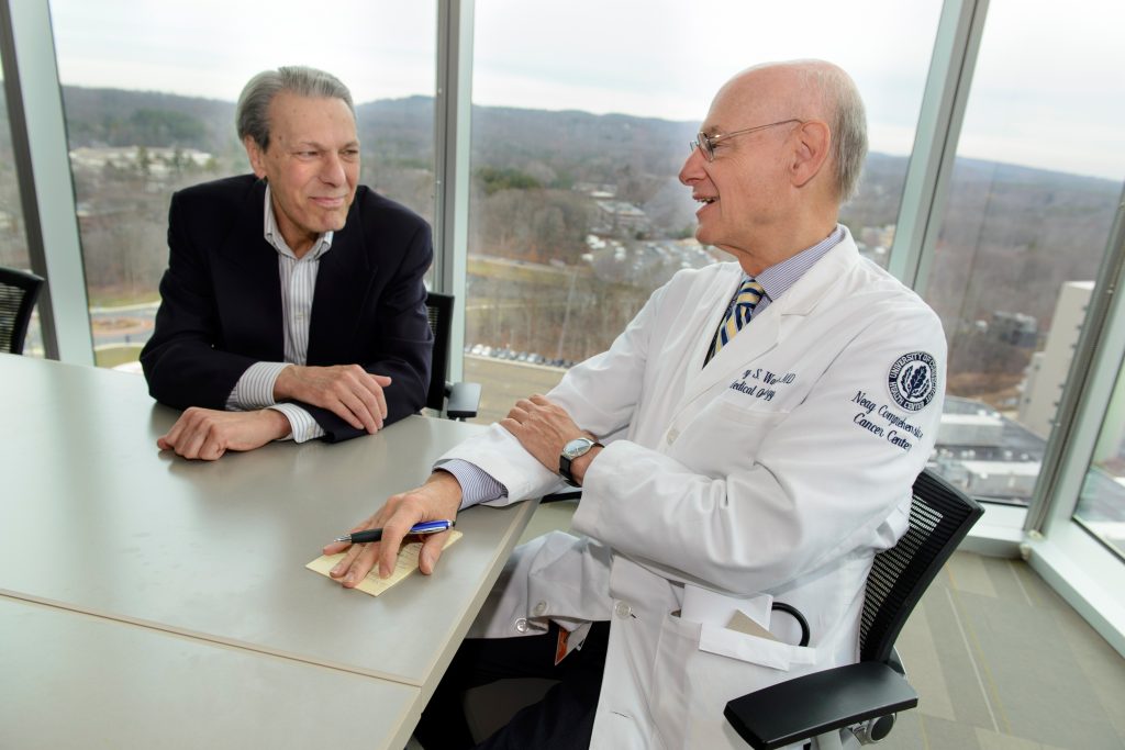 Lung cancer patient Michel Gueret, left, with his oncologist at UConn Health, Dr. Jeffrey Wasser. (Janine Gelineau/UConn Health Photo)