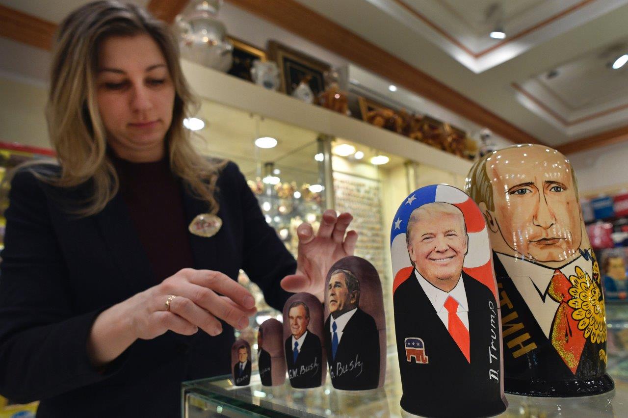 An employee displays traditional Russian wooden nesting dolls depicting US President-elect Donald Trump, Russian President Vladimir Putin at a gift shop in central Moscow just days ahead of Trump's inauguration. ( Alexander Nemenov/AFP/Getty Images)