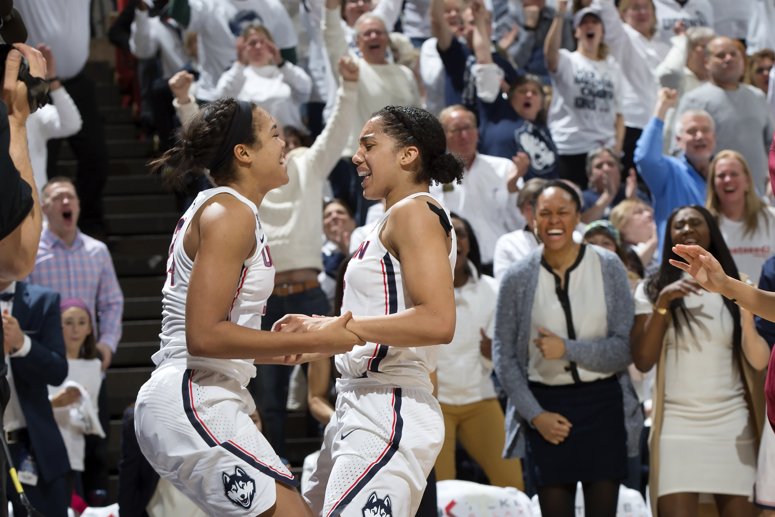Napheesa Collier, left, and Gabby Williams celebrate the team's 100th consecutive win. (Stephen Slade '89 (SFA) for UConn)