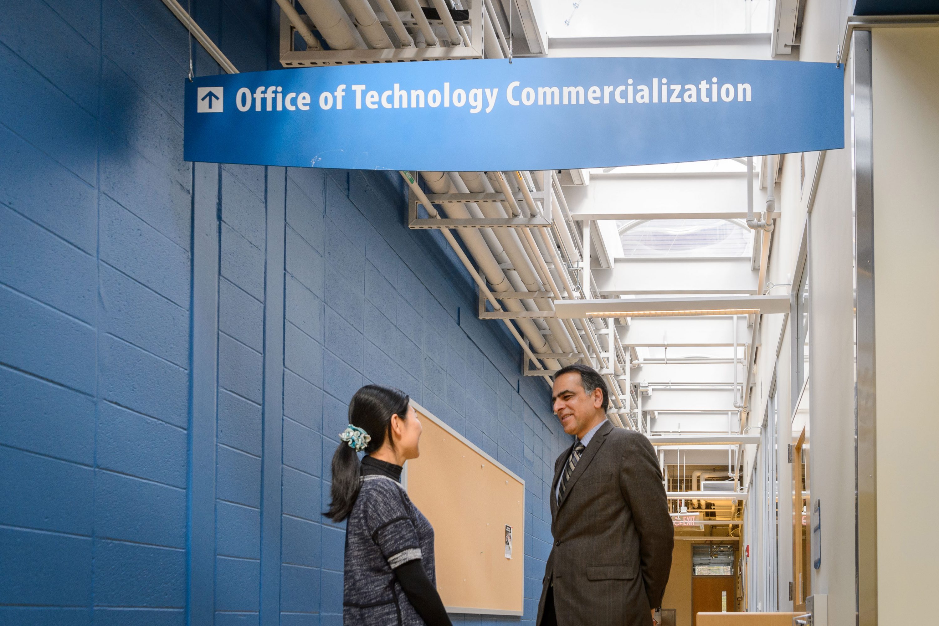 Mostafa Analoui, executive director of venture development., right, speaks with Ying Liu of ReinEsse LLC at the Cell and Genome Sciences Building in Farmington on Feb. 8, 2017. (Peter Morenus/UConn Photo)