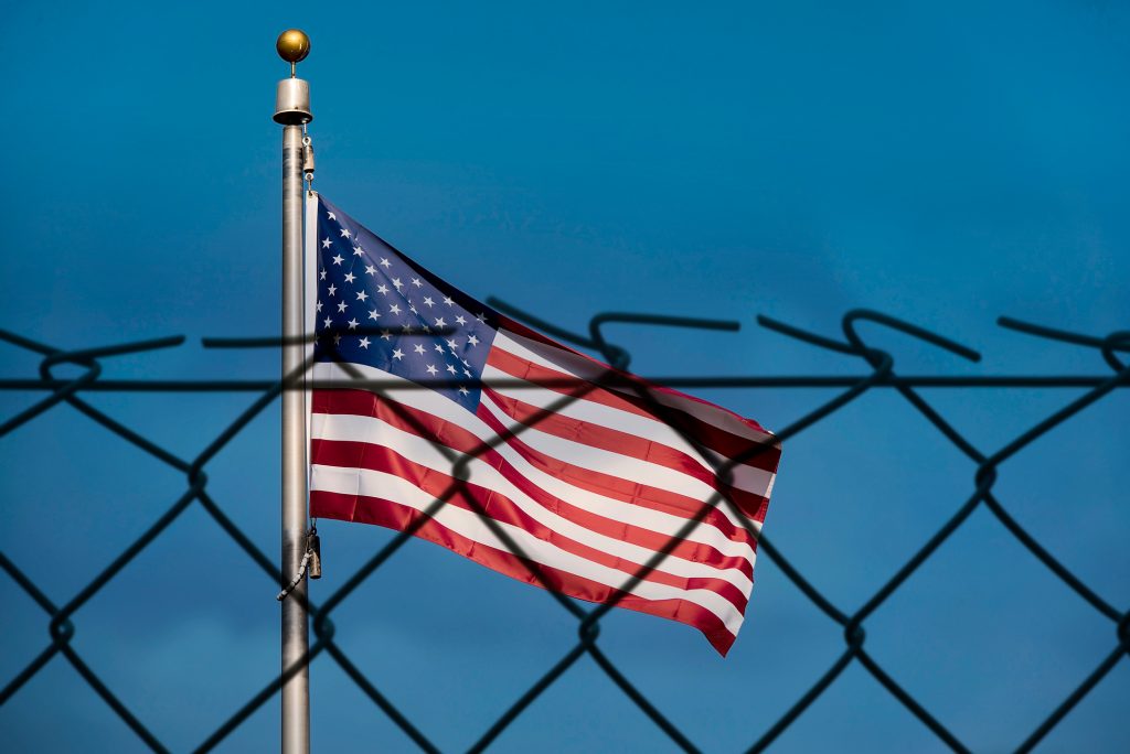 American flag and fence. (Alxey Pnferov via Getty Images)