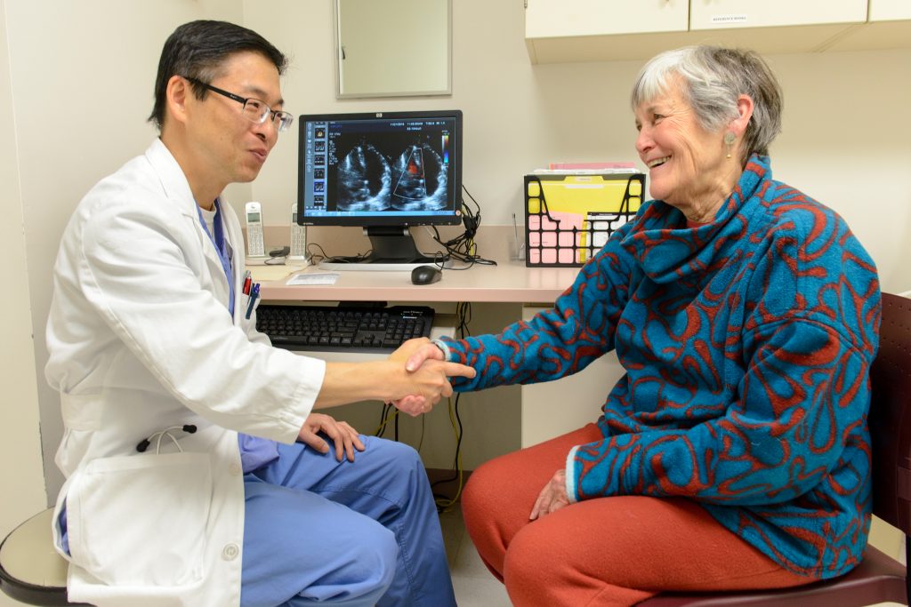 Dr. Juyong Lee, director of endovascular interventional medicine at UConn Health, left, with heart patient Barbara Graham. (Janine Gelineau/UConn Health Photo)