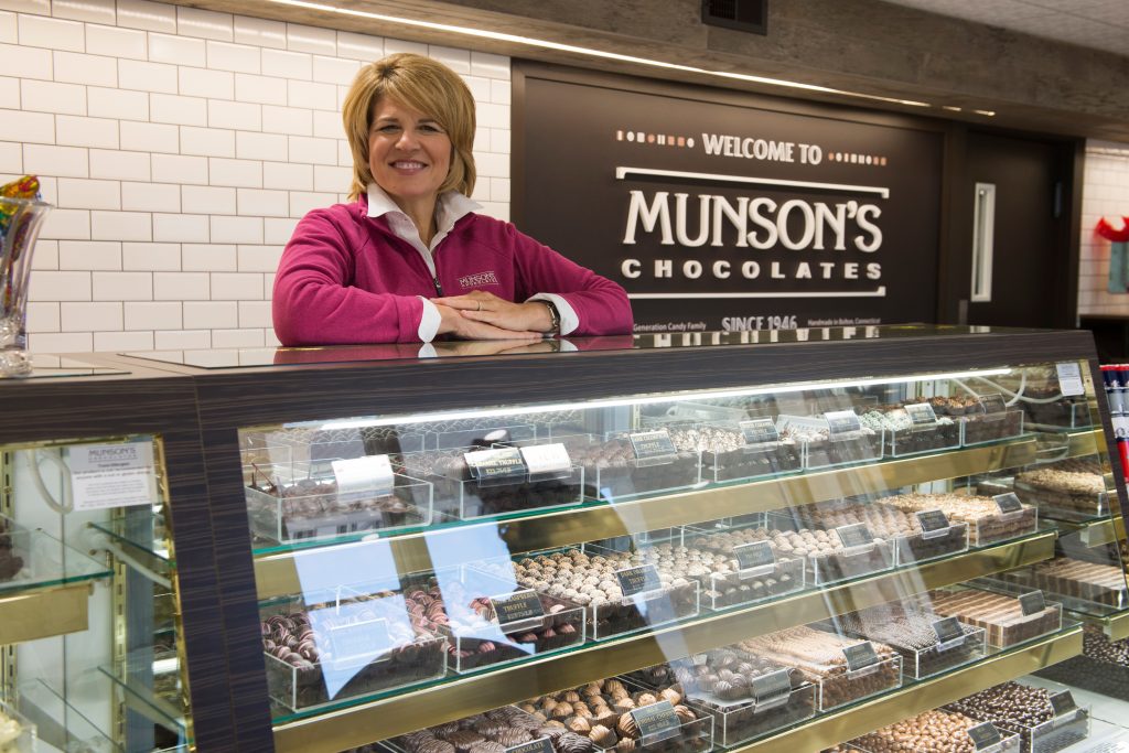 Karen Munson '86 (CLAS) stands at the counter at Munson's Chocolates in Bolton. (Peter Morenus/UConn Photo)
