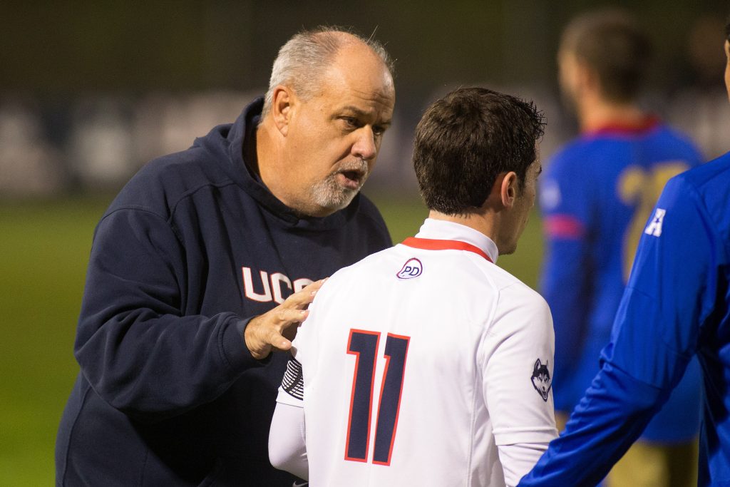 Men's soccer head coach Ray Reid speaks with Adria Beso Marco. (File Photo by Stephen Slade '89 (SFA) for UConn)