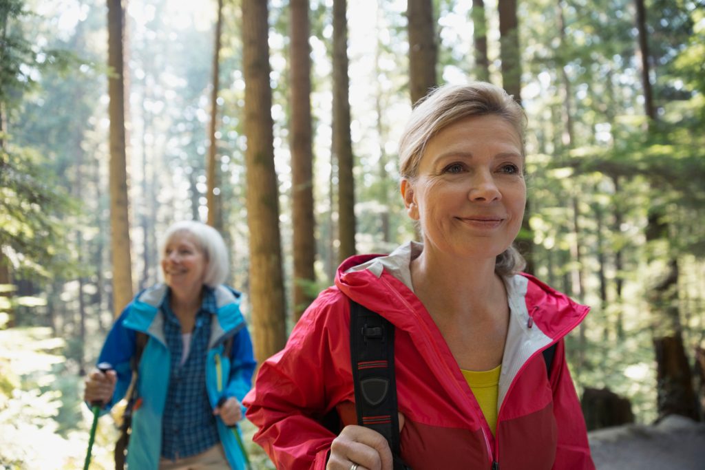 Two women walking in the woods. (Getty Images)