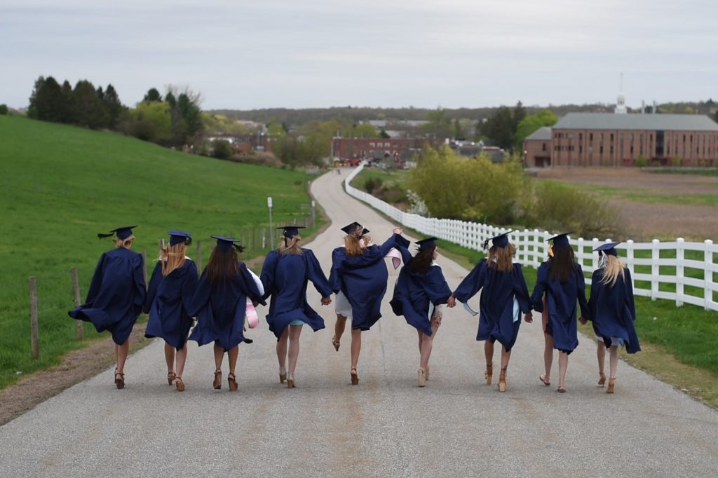 Soon-to-be-graduates visit some familiar places on campus for photo opps wearing their caps and gowns. (Ryan Glista/UConn Photo)