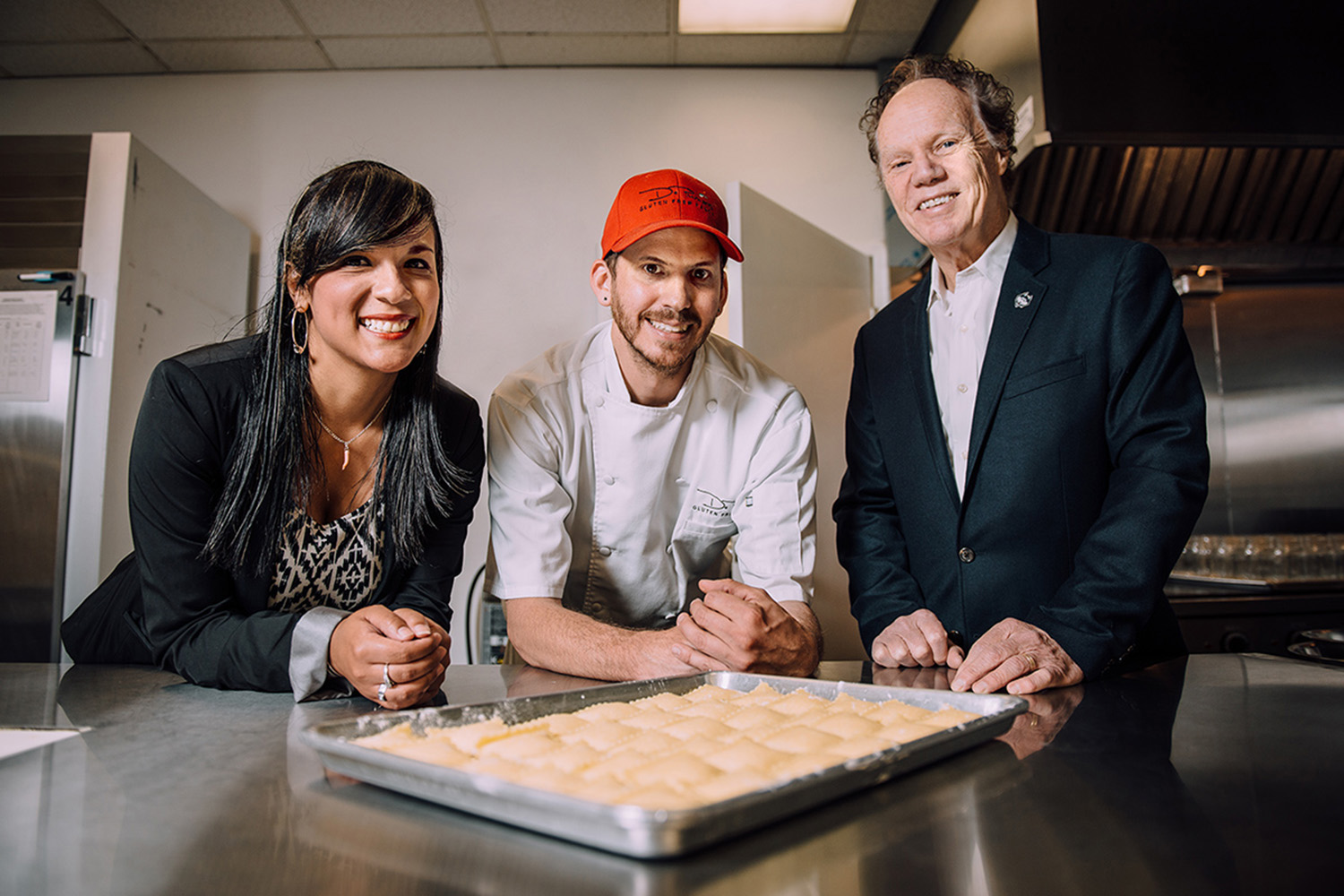 MBA student Shirley Tarabochia (left), JohnDePuma (center), founder of a gluten-free pasta business, and Wayne Bragg, instructor-in-residence in the School of Business. Tarabochia helped DePuma upgrade his business practices. (UConn School of Business Photo)