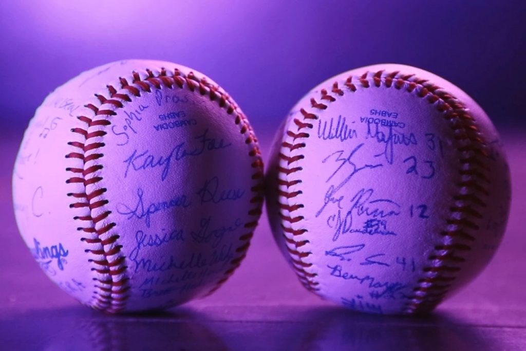 Two baseballs, one signed by the music students, the other by the baseball team. (Kenneth Best/UConn Photo)