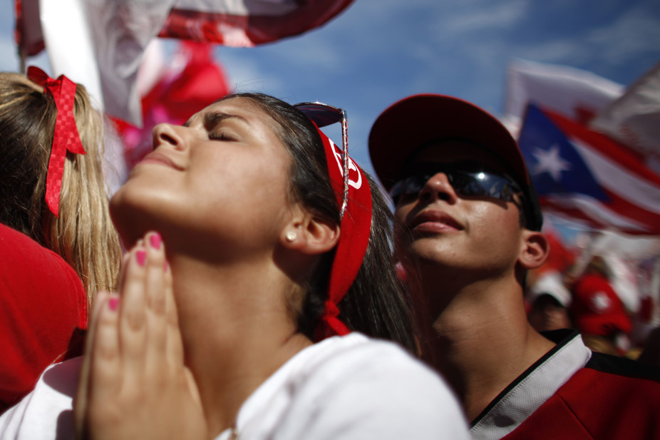 Puerto Rican citizen gestures during political rally in 2012. AP/Ricardo Arduengo