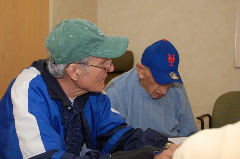 Two of the participants in the Baseball Reminiscence Program at River House Adult Care Center in Cos Cobb, Connecticut. (Kenneth Best/UConn Photo)