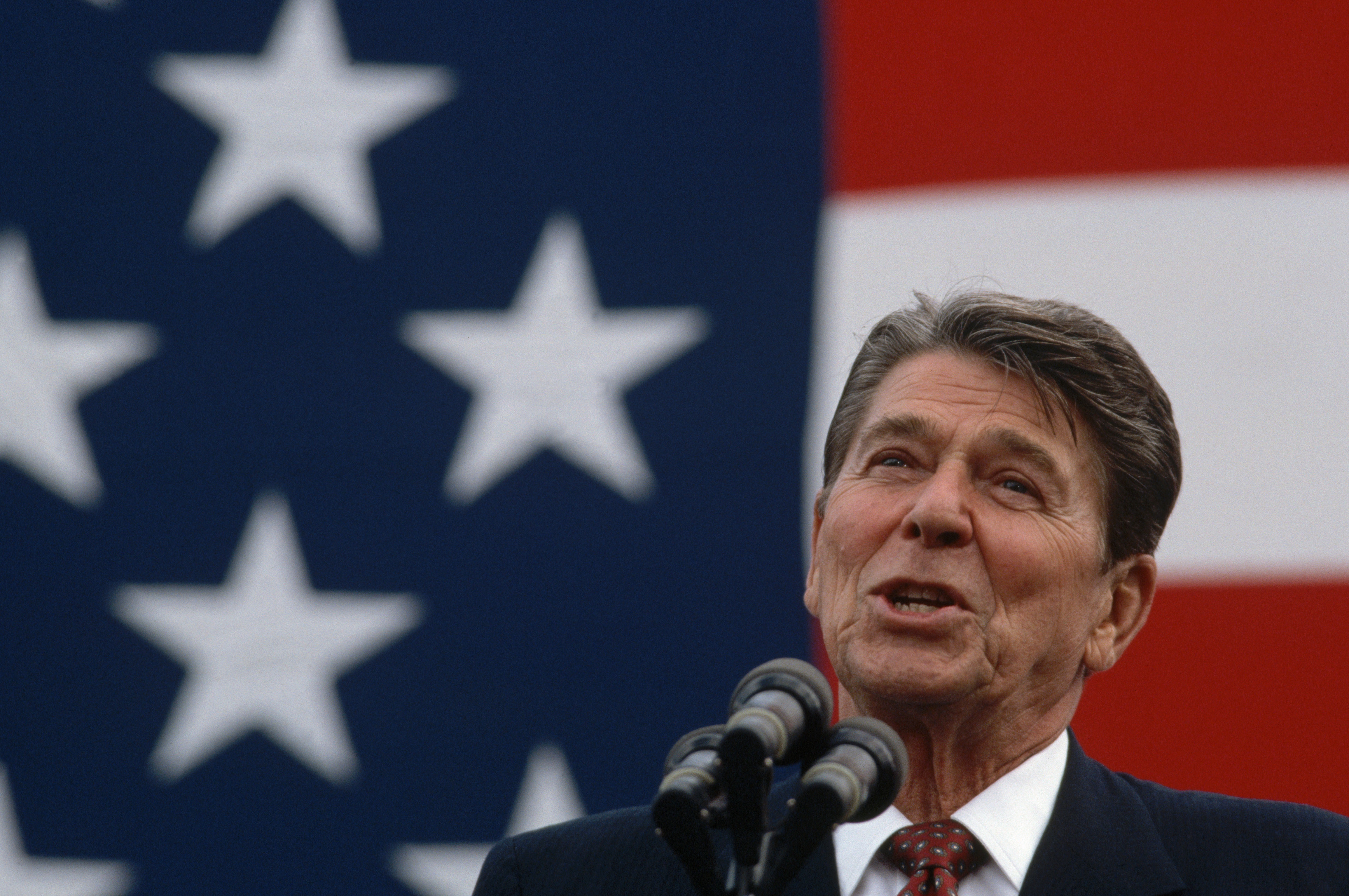 President Ronald Reagan makes a stump speech in front of a large American flag. (Photo by Wally McNamee/CORBIS via Getty Images)