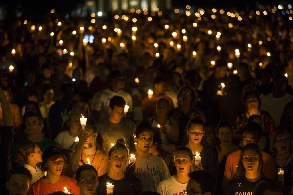 Thousands gather with candles to march along the path that White Supremacists took the prior Friday with torches on the University of Virginia Campus in Charlottesville, United States on August 16, 2017. (Photo by Samuel Corum/Anadolu Agency/Getty Images)