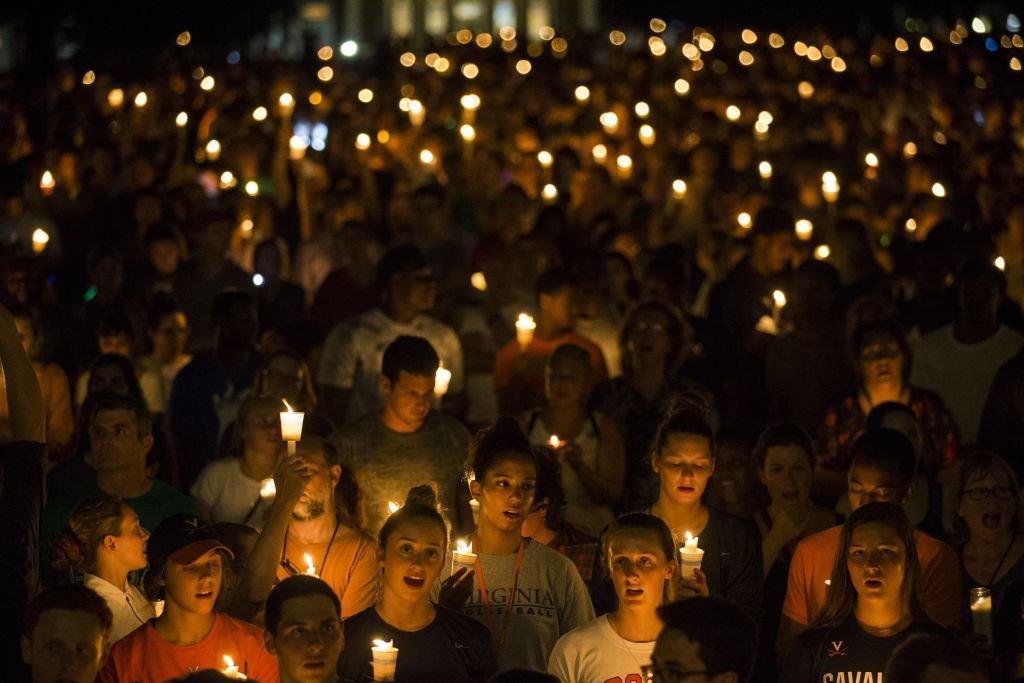 Thousands gather with candles to march along the path that White Supremacists took the prior Friday with torches on the University of Virginia Campus in Charlottesville, United States on August 16, 2017. (Photo by Samuel Corum/Anadolu Agency/Getty Images)