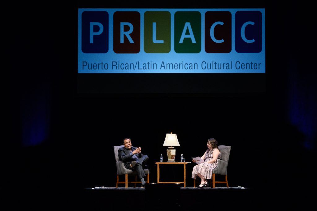 John Quiñones, left, host of the ABC show "What Would You Do?" speaks with Fany Hannon '08 MA, PRLACC director, during the "Illuminating the Path" lecture at the Jorgensen Center for the Performing Arts on Sept. 19, 2017. (Peter Morenus/UConn Photo)