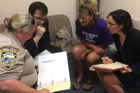 Professor Jessica Rubin, right, discusses a case with, from left, West Haven Animal Control Officer Denise Ford, law student Christopher Kelly, and Desmond’s Army co-founder Christine Kiernan.