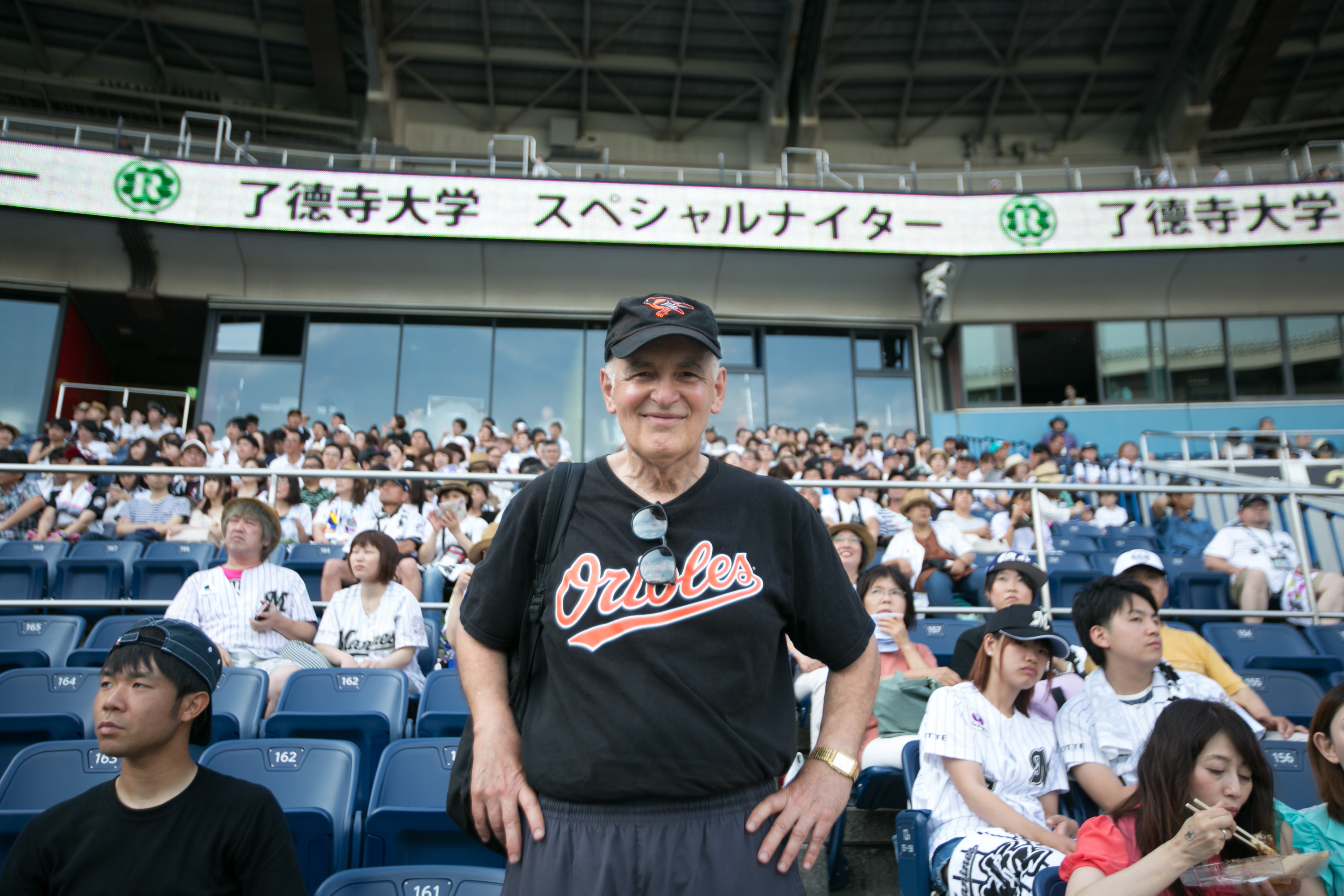 Steven Wisensale, professor of human development and family studies, watches a baseball game in Japan. (Chris Moore for UConn)