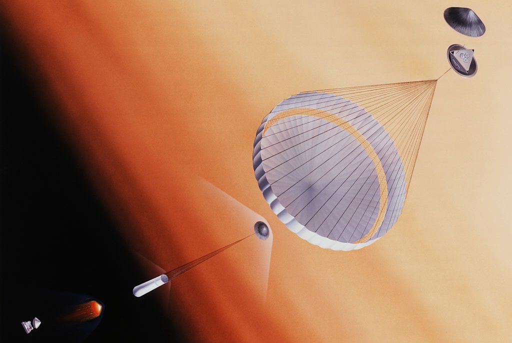 Artist's rendition of the descent of the Pathfinder lander onto planet Mars. The lander will descend by parachute, and will be protected by airbags which will deflate upon impact. The three petals protecting the lander will open after it lands. In this rendition the petals are partially opened. (Photo by © CORBIS/Corbis via Getty Images)