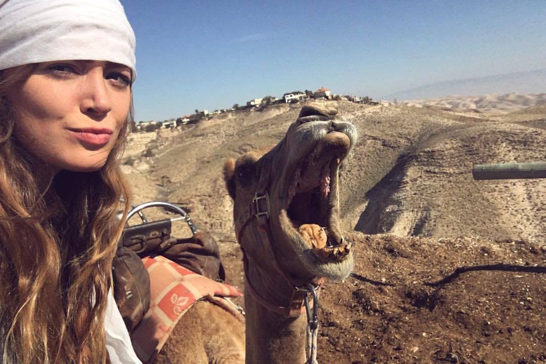 Among her many travels, Olivia Balsinger '14 CLAS) has hobnobbed with camels in the Masada Desert in Israel. (Photo courtesy of Olivia Balsinger)