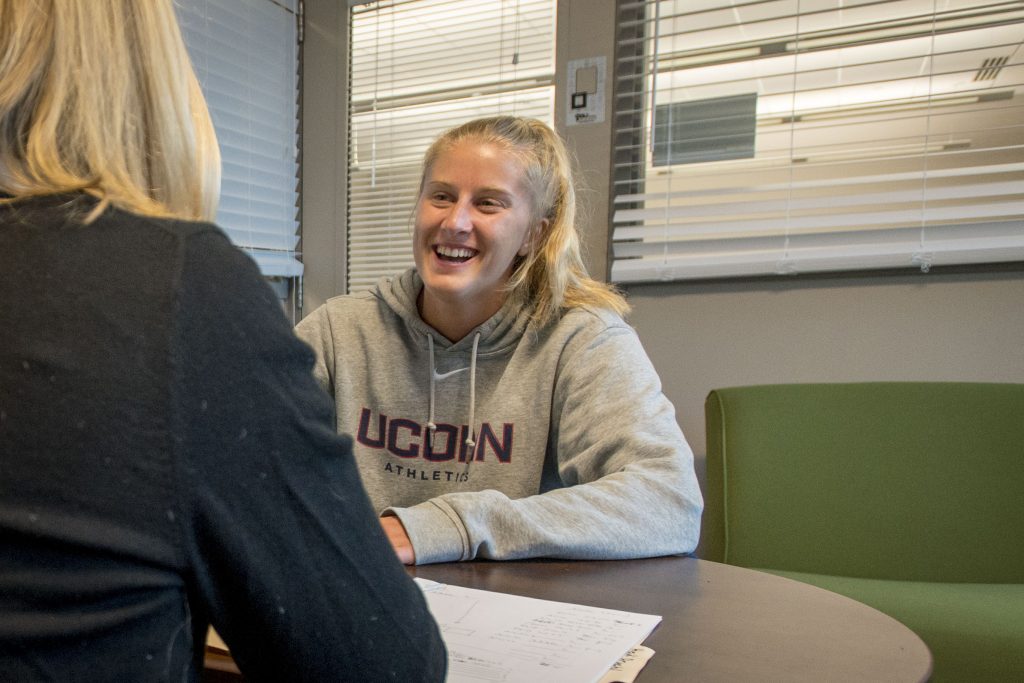 Student-athlete Heidi Druehl, Women’s Soccer, speaks with her academic counselor Ingrid Hohmann about an upcoming exam she will need to take while traveling with the team. (Sean Flynn/UConn Photo)