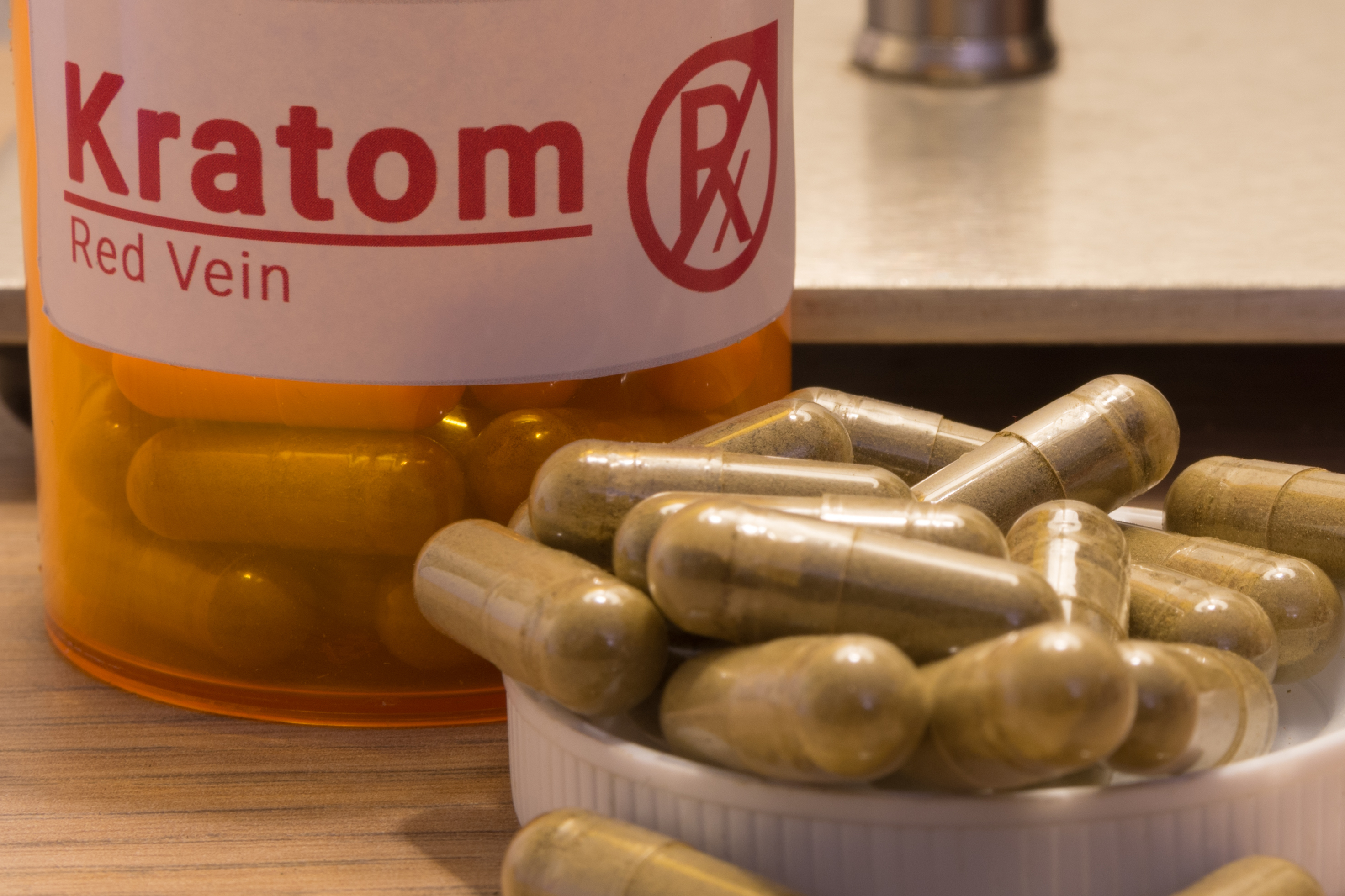 Image of actual kratom pills with a faux prescription logo. (Getty Images)
