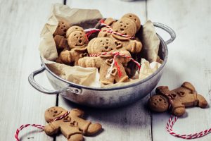 Gingerbread man cookies and Christmas decorations on white background. (Getty Images)