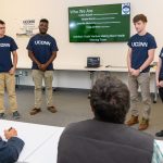 Colton Kopcik '19 (CLAS) left, Chibuike Ukwuoma '19 (BUS), Craig Carlson '19 (CLAS), and Shayla Morris '19 (CLAS) of Healthy Roots speak about their efforts to develop a certification for best farm labor practices during the Entrepreneurial & Innovation Student Huddle. (Peter Morenus/UConn Photo)