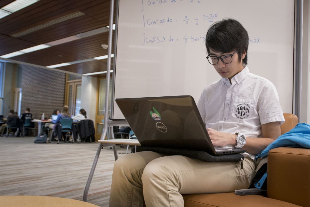 International Student Wei ‘Toby’ Xinhai studying math at the Homer Babbidge Library on Dec. 12, 2017. (Sean Flynn/UConn Photo)