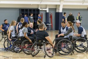 Students huddle for wheelchair basketball at the Student Recreation Center on Nov. 30. (Garrett Spahn ’18 (CLAS)/UConn Photo)