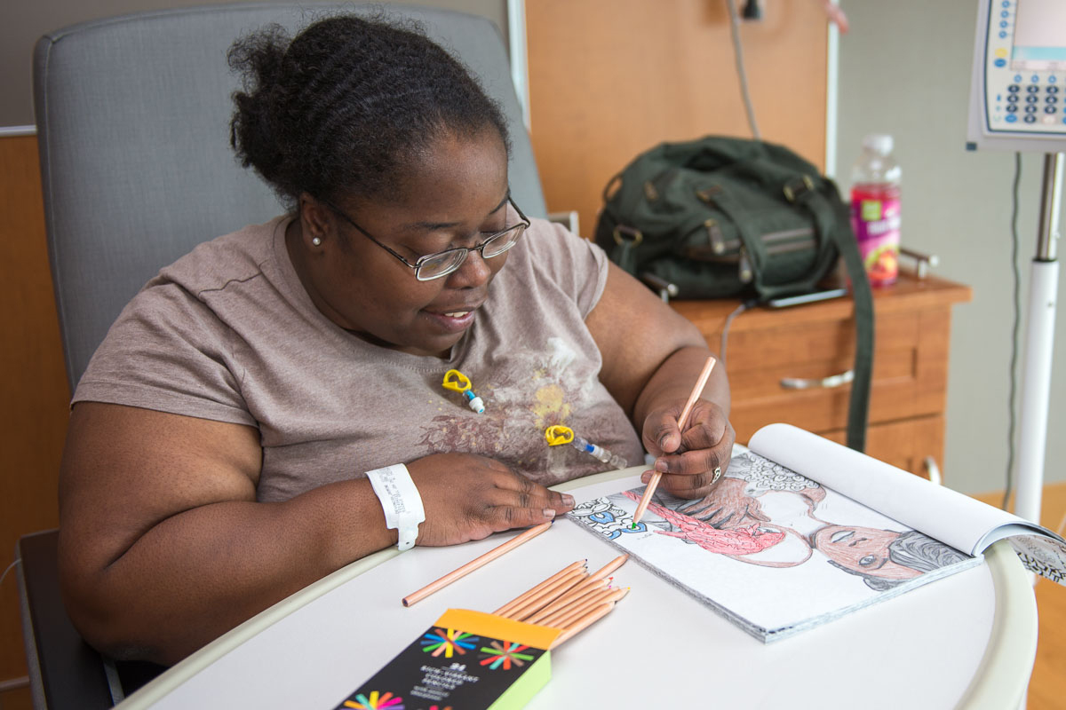 A local artist is brightening the holiday season using his coloring books as art therapy for his fellow UConn Health patients living with sickle cell and other diseases. (Tina Encarnacion/UConn Health Photo)