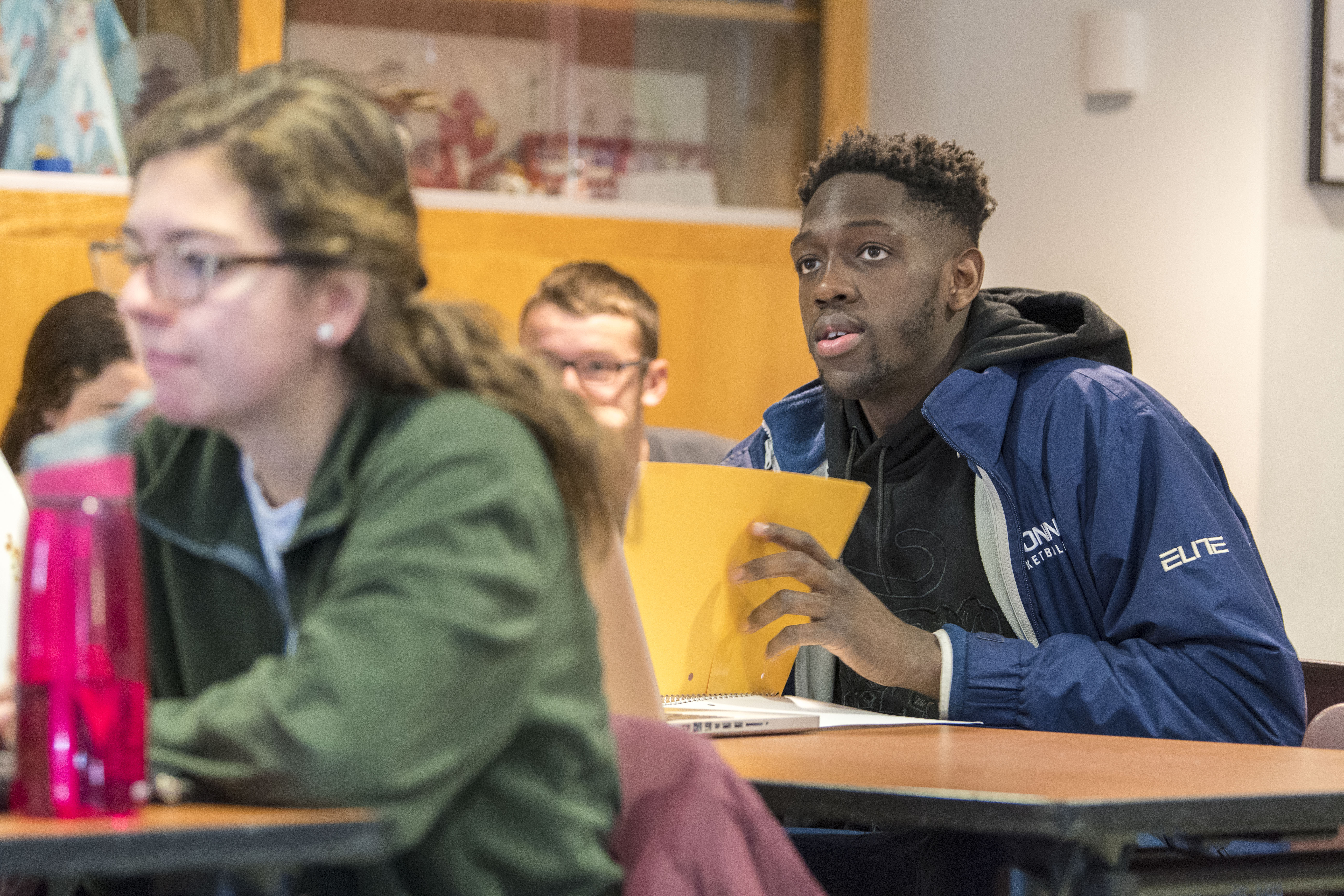 Student-athlete Mamadou Diarra, Men’s Basketball, in a History of Immigrants course taught by assistant professor Jason Chang at the Asian American Cultural Center on Dec. 7, 2017. (Sean Flynn/UConn Photo)