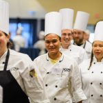 Michelle Perez of Buckley dining, and other competitors walk into Rome Ballroom at the start of the Boiling Point competition of UConn Dining's 18th annual Culinary Competition on Jan. 9, 2018. (Peter Morenus/UConn Photo)