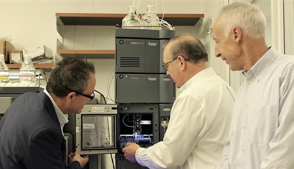 Yaworski, Hill, and Grant look at the Mass Spectrometer.