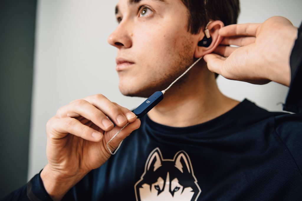 Benjamin Grosse '21 (BUS) wearing mXers earbuds. (Nathan Oldham)