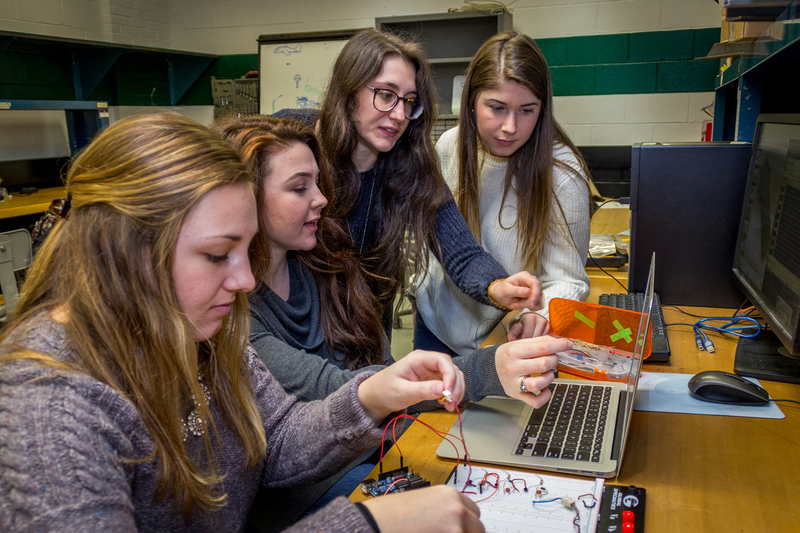 The team of four biomedical engineering students work on their project. (Christopher Larosa/UConn Photo)
