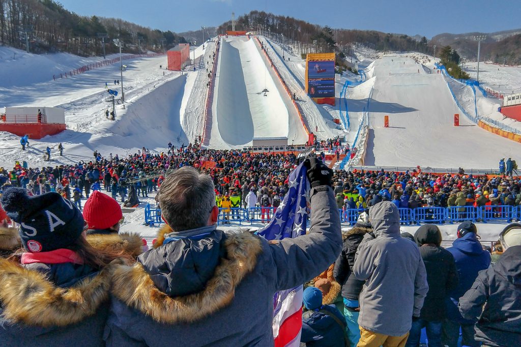 Fans of Chloe Kim cheer after she completes her winning run on the halfpipe during the Ladies Snowboard Halfpipe final at Bokwang Phoenix Park. (Peter Morenus/UConn Photo)