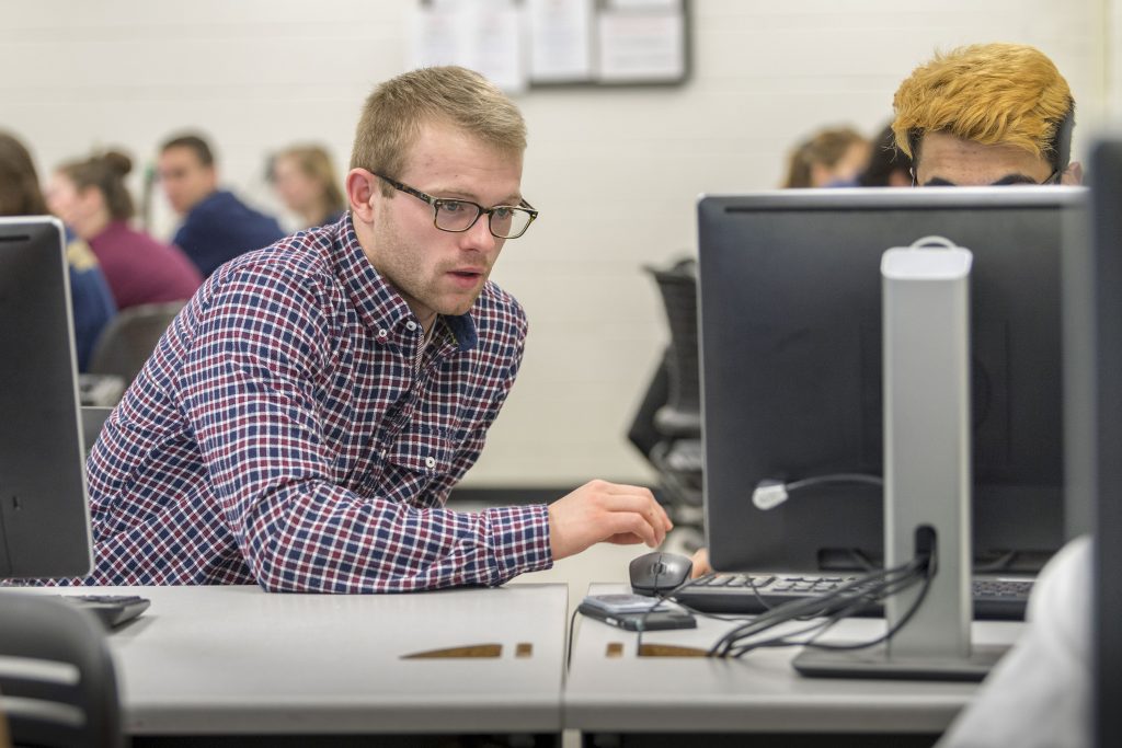 (left) Men's swimming student athlete: Matt Dagenais ‘19 (ENG) in his Computer Aided Design class at the School of Engineering's Castleman Building on Feb. 20, 2018. (Sean Flynn/UConn Photo)