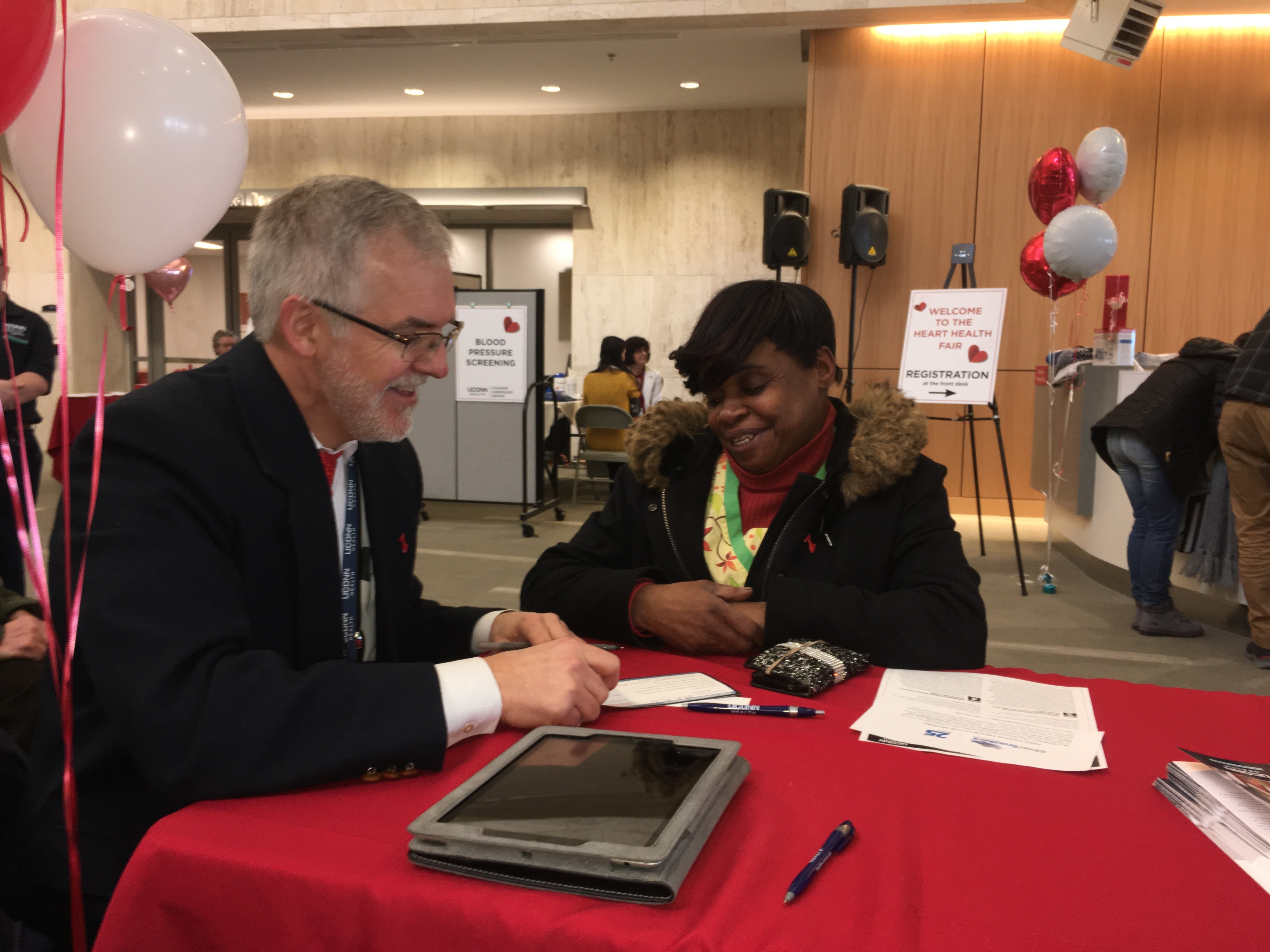 Chir-lane Johnson of New Britain gets the results of her free screenings and a personalized heart health assessment at UConn Health's Heart Health Fair on National Wear Red Day on Feb. 2 (UConn Health Photo/Lauren Woods).