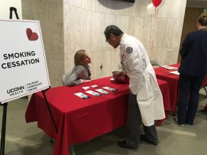 Dr. Bruce Liang, director of the Calhoun Cardiology Center visited the Heart Health Fair's educational booths including the Smoking Cessation Program's table hosted by Diahann Wilcox, APRN (UConn Health Photo/Lauren Woods). 