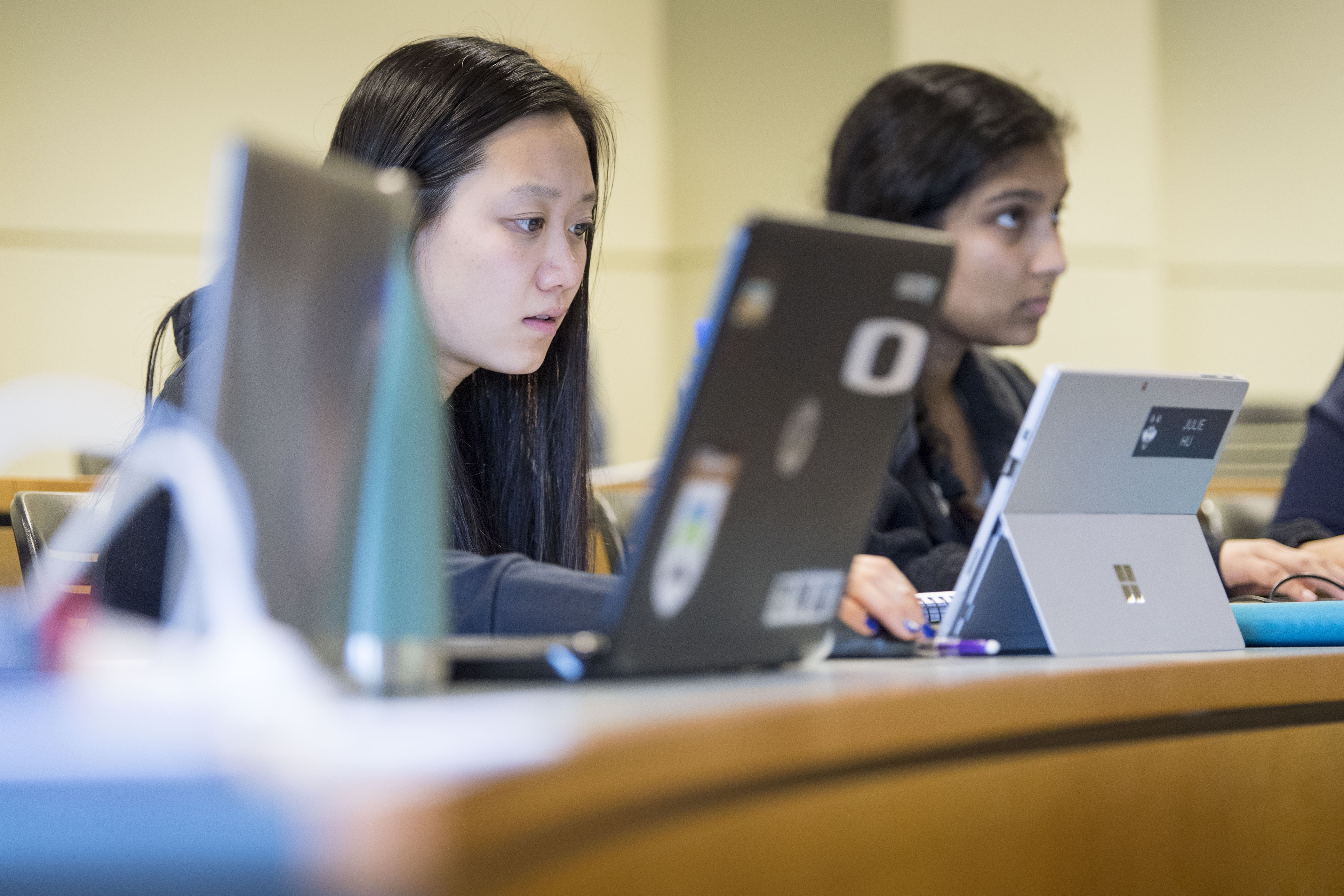 Student-athlete Julie Hu ’19 (CLAS) listening to a finance lecture by assistant professor Cristian Pinto-Gutierre in the School of Business on Feb. 21, 2018. (Sean Flynn/UConn Photo)