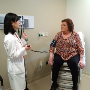 Lynn Michaud with Dr. Agnes Kim at her follow-up appointment at the Cardio-Oncology Program at UConn Health (UConn Health Photo/Lauren Woods).