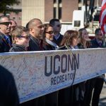 UConn Recreation employees pose for a photo with a signed beam to be installed during the topping off ceremony for the new Student Recreation Center on Feb. 27, 2018. (Peter Morenus/UConn Photo)