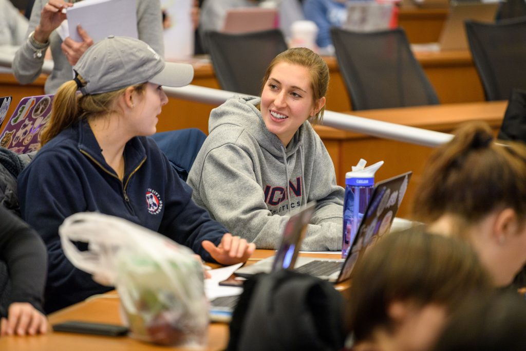 Ashley Rich '20 (NUR) speaks with a classmate during a nursing class at the Carolyn Ladd Widmer Wing of Storrs Hall on Feb. 1, 2018. (Peter Morenus/UConn Photo)